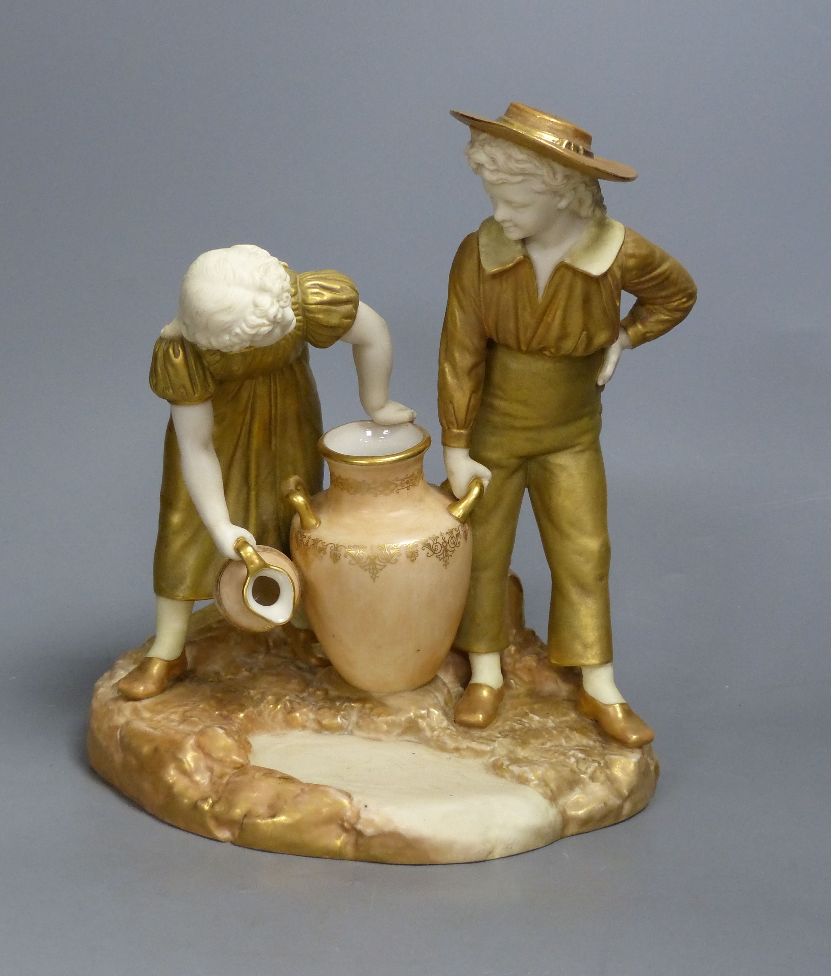 A Royal Worcester group of a boy and a girl, date code for 1917, height 24cm